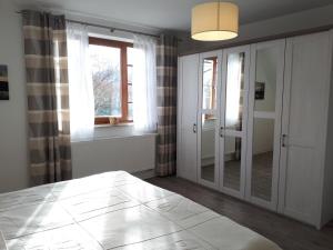 a room with a hallway with glass doors and a window at Ilmperle im Hubertushof in Bad Berka