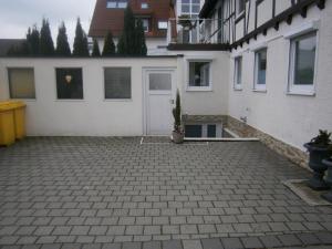 a driveway in front of a white house at Bodensee Ferienwohnung Claudia 4 in Friedrichshafen