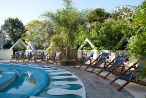 a group of chairs sitting next to a swimming pool at Espacio Domu in Cañuelas