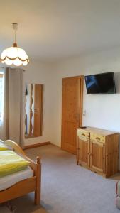 a bedroom with a bed and a tv on a wall at Appartement Stubaital in Neustift im Stubaital