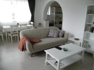 a living room with a couch and a table at Iarca Cottage in Bucharest