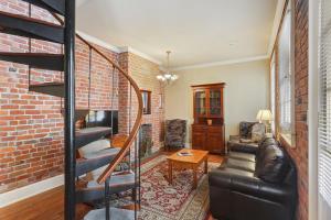 a living room with a brick wall at Grenoble House in New Orleans