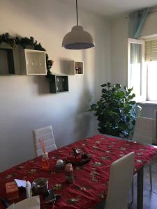 a dining room table with a red table cloth on it at L'Alloggio Perfetto in Putignano +8 photos