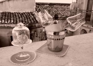 a bottle of wine and a glass on a table at B&B Al Centro Storico in Agrigento