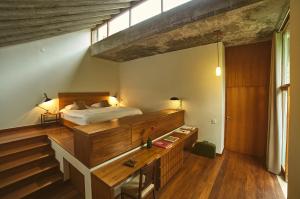 a bedroom with a bed and stairs in it at Chez Georges in Rio de Janeiro