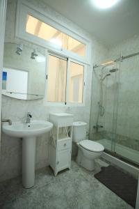 a bathroom with a sink and a toilet and a shower at COTILLO SEA in Cotillo +10 photos