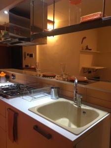 a kitchen with a sink and a stove at Ancient walls home in Genoa +20 photos