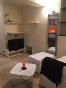 a living room with a tv and a couch and a table at Ancient walls home in Genoa