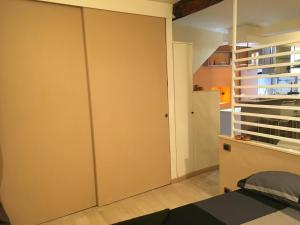 a bedroom with a closet and a bed and a staircase at Ancient walls home in Genoa