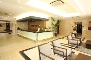 a lobby with chairs and a bar in a building at Hotel Hokke Club Oita in Oita