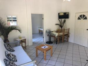 a living room with a couch and a table at Diamondview in Soufrière