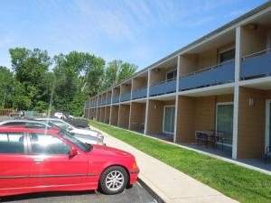 a red car parked in front of a building at Crystal Inn - Neptune in Neptune City