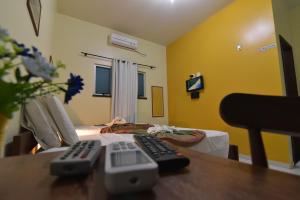 a room with two remote controls on a table at Pousada Paraíso dos Lençóis in Barreirinhas