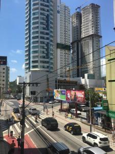 a busy city street with cars and buildings at Balneário Camboriú lindo apto proximo Mar in Balneário Camboriú +3 photos