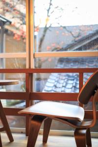 a table and a chair in front of a window at TAMACO in Kanazawa in Kanazawa