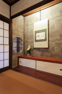 a living room with a table and a wall at TAMACO in Kanazawa in Kanazawa