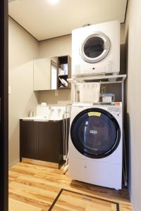 a washer and dryer in a small kitchen at TAMACO in Kanazawa in Kanazawa