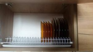a shelf with a bunch of knives in a cabinet at Gudauri Ski Studio in Gudauri