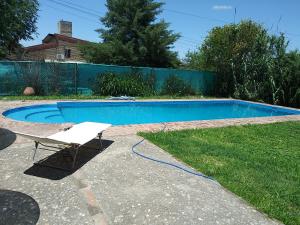 a white chair next to a swimming pool at Al lado in Córdoba