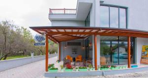 a building with awning and tables and chairs at Room Room Motel in Sapanca