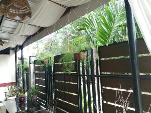 a fence with a bunch of plants on it at Cozy Inn Mactan in Mactan