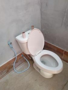 a bathroom with a toilet with a water hose at Lanta Local Hut in Ko Lanta