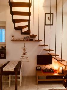a dining room with a staircase and a table at Mini Appartamento Centro Storico in Pescocostanzo