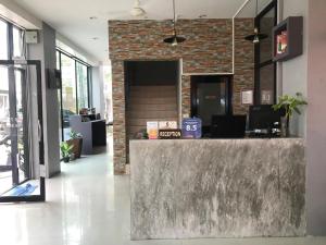 a lobby with a stone counter and a brick wall at Holiday Home Patong in Patong Beach