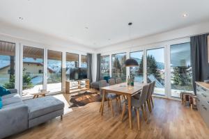 a living room with a table and a couch at Deluxe Apartment Berglust in Schladming