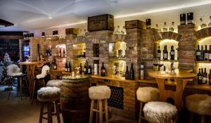 a bar with a bunch of bottles of wine at VALAMAR Obertauern in Obertauern