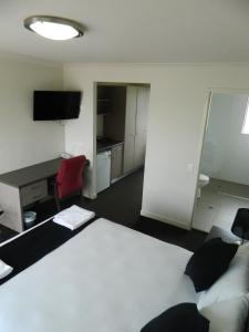 una camera d'albergo con letto, scrivania e computer di Dooleys Tavern and Motel Capella a Capella