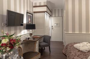 a bedroom with a desk and a bed and a tv at Europa Hotel Kühlungsborn in Kühlungsborn