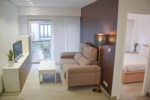 a living room with a couch and a bed at Modern & spacious apartment near La Concha Bay in Donostia-San Sebastián