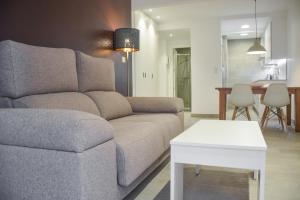 a living room with a couch and a table at Modern & spacious apartment near La Concha Bay in Donostia-San Sebastián