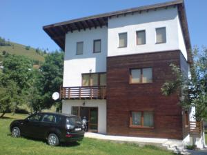 a black car parked in front of a house at Casa Ambasadorului in Bran