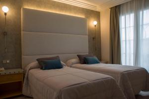 Postel nebo postele na pokoji v ubytování Hotel Complejo París