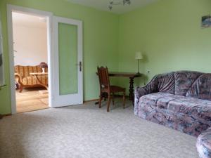 a living room with a couch and a table at Schloßblick in Lohmen