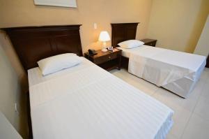 Postel nebo postele na pokoji v ubytování Hotel Formosa Daet