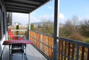 - une terrasse couverte avec 2 chaises et une table sur un balcon dans l'établissement Niederfeld83, à Winterthour
