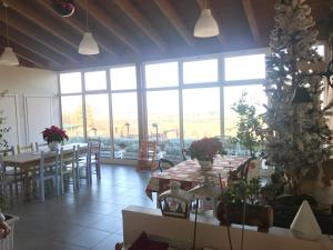 a dining room with a christmas tree and tables at Fattoria Belvedere in San Lazzaro di Savena