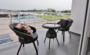 three chairs and a table on a balcony with a view at St Georges Height in Accra +32 photos