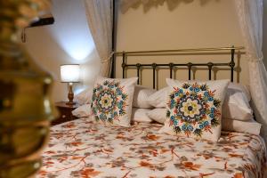 a bedroom with a bed with two pillows on it at Maria Giovanna Guest House in Marsalforn