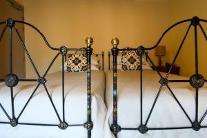 two beds in a room with white sheets at Maria Giovanna Guest House in Marsalforn