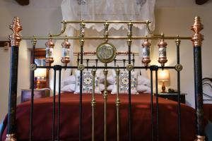 a metal bed with a red bedspread and a canopy at Maria Giovanna Guest House in Marsalforn