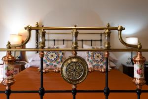 a close up of a bed with a metal frame at Maria Giovanna Guest House in Marsalforn