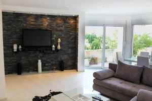 a living room with a couch and a brick wall at Villa la vie in Ulcinj