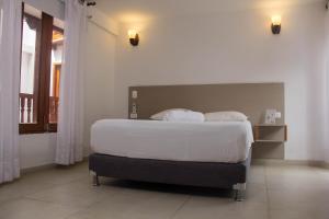 Postel nebo postele na pokoji v ubytování Akel House Hotel