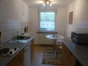 a kitchen with a counter and a sink and a window at Ferienwohnung Zur Alten Eiche in Frohburg