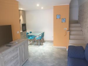 a kitchen and dining room with a table and chairs at Porto di mare luxury home in Giovinazzo