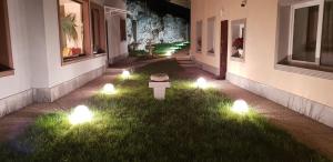 a garden with lights in the grass next to a building at Central Apartment DumDix Brasov in Braşov